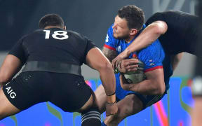 France's Remy Grosso is tackled by All Blacks Ofa Tu'ungafasi and Sam Cane.