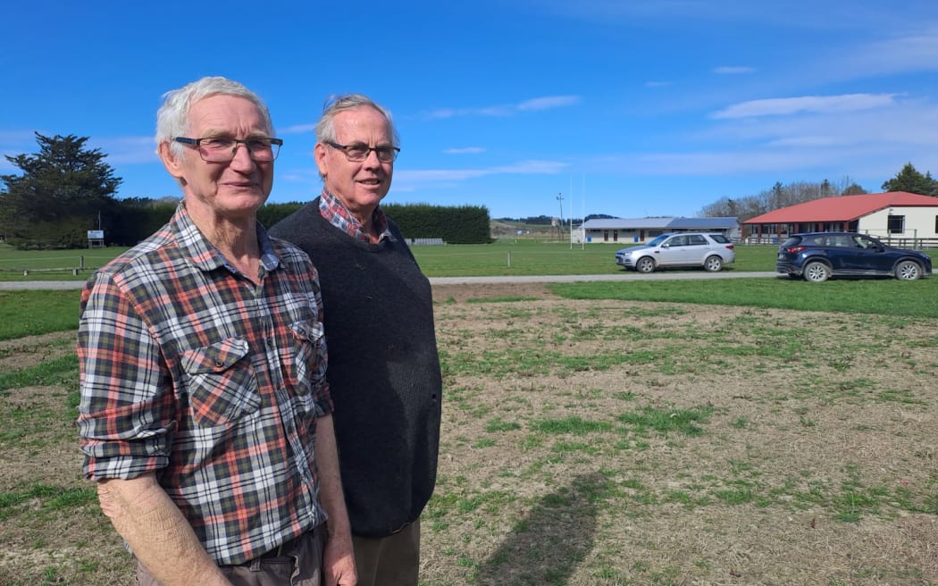 Cheviot Lions Helipad Committee chair Giles Pinfold (left) and committee member Emmet Daly on the Miller Street Reserve site for the proposed concrete helipad.