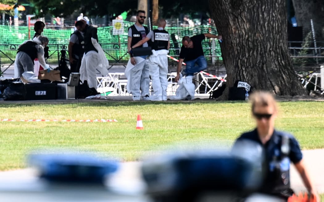 French forensic police officers work at the scene of a stabbing attack in the 'Jardins de l'Europe' park in Annecy, in the French Alps, on June 8, 2023.