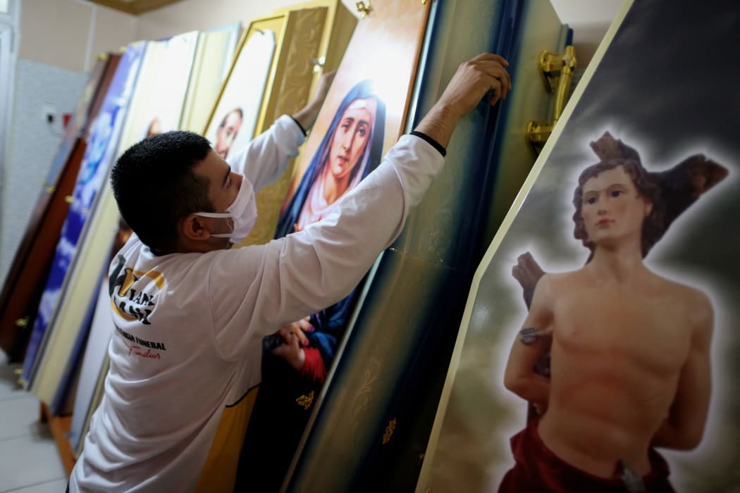 An employee at Viana Funeral services arranges coffins, during the Covid-19 coronavirus pandemic in Manaus, Brazil, where the City Hall warned that stock of coffins in the region is likely to run out, on April 27, 2020.