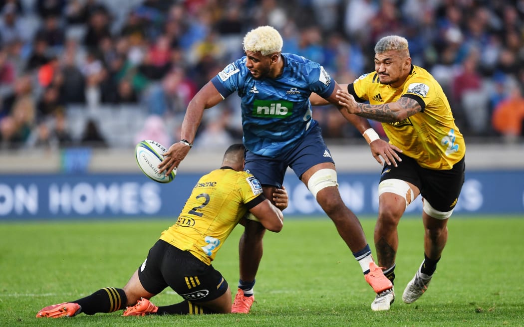 Blues forward Hoskins Sotutu off-loads against the Hurricanes.