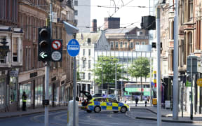 A police officer stands by a cordon outside on Market Street in Nottingham, central England, during a 'major incident' in which three people have been found dead. UK police on Tuesday locked down the central English city of Nottingham after three people were found dead in a "horrific and tragic incident". A 31-year-old man had been arrested on suspicion of murder, police said, adding that they were also investigating another incident which they believed was linked, in which a van had attempted to run over three people. (Photo by Darren Staples / AFP)