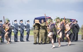 The he taua (war party) leads the caskets towards the awaiting families of the two soldiers.
