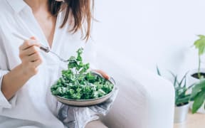 woman eating kale
