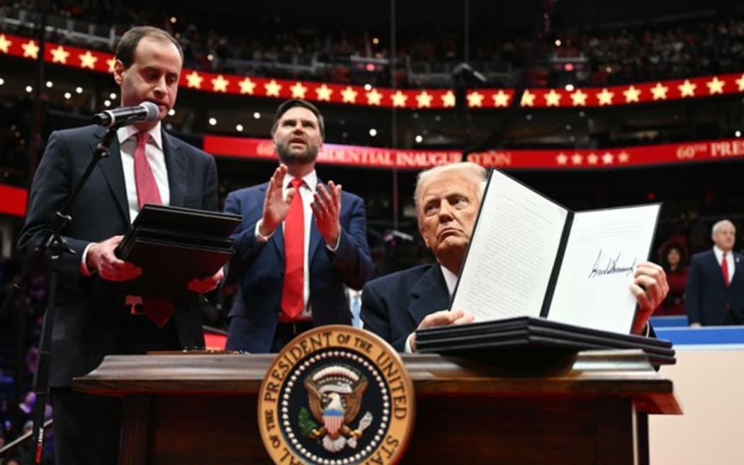 US President Donald Trump holds an executive order announcing the US withdrawal from the Paris Agreement, after his inauguration in Washington, DC, on Jan. 20, 2025.