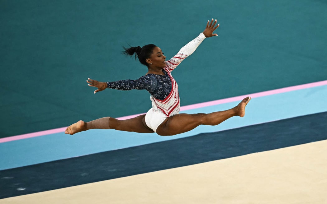 US' Simone Biles competes in the floor exercise event of the artistic gymnastics women's team final during the Paris 2024 Olympic Games at the Bercy Arena in Paris, on July 30, 2024. (Photo by Paul ELLIS / AFP)