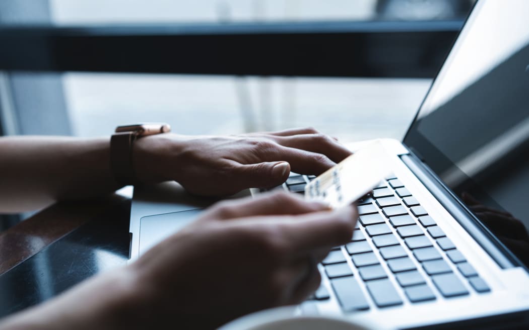 Hands of a woman making a payment online.