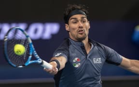John Isner of the US hits a return against Fabio Fognini of Italy during their tenth session men's singles match on day five of the ATP Cup tennis tournament in Perth on January 7, 2020.