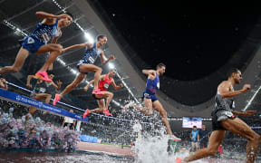 Runners compete in the men's 3000m steeplechase