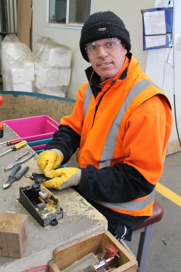 A photo of Sam Nielson who works in the e-scrap recycling department