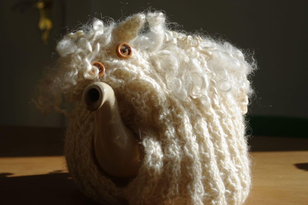 tea pot with knitted tea cosy sheep