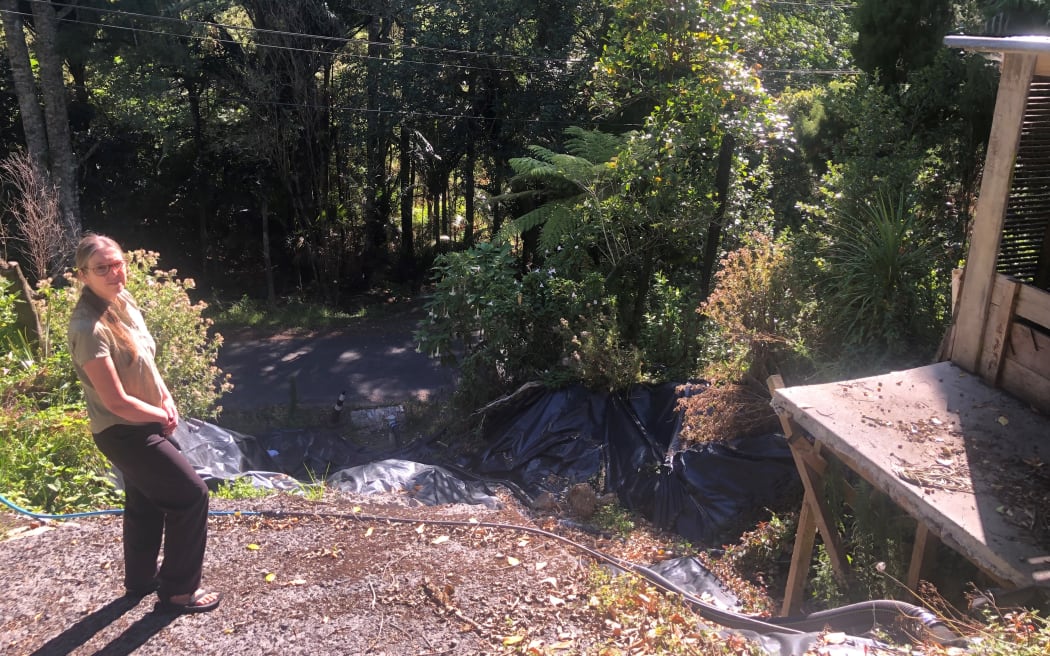 Catherine Albiston on the edge of the slip that's rendered her driveway useless and her car unusable
