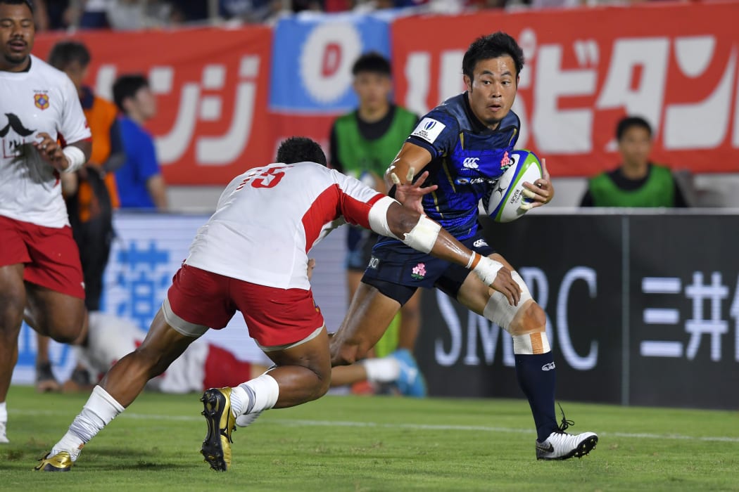 Japan's Kenki Fukuoka runs past David Halaifonua of Tonga to score
