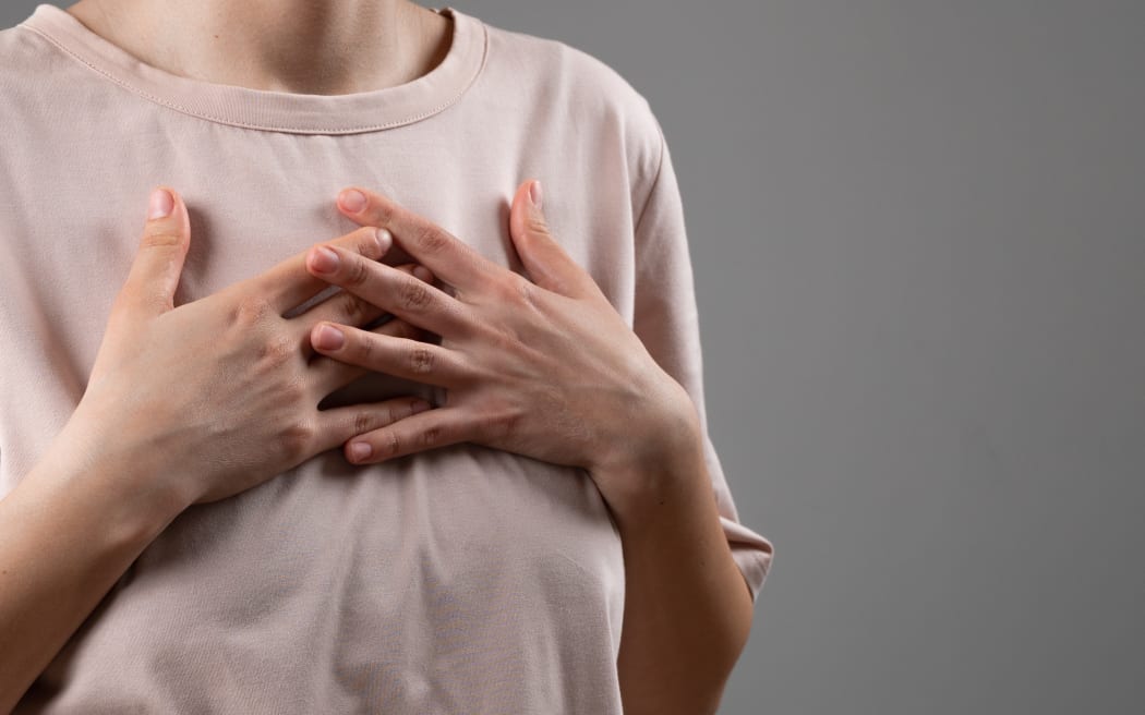 Woman holding chest
