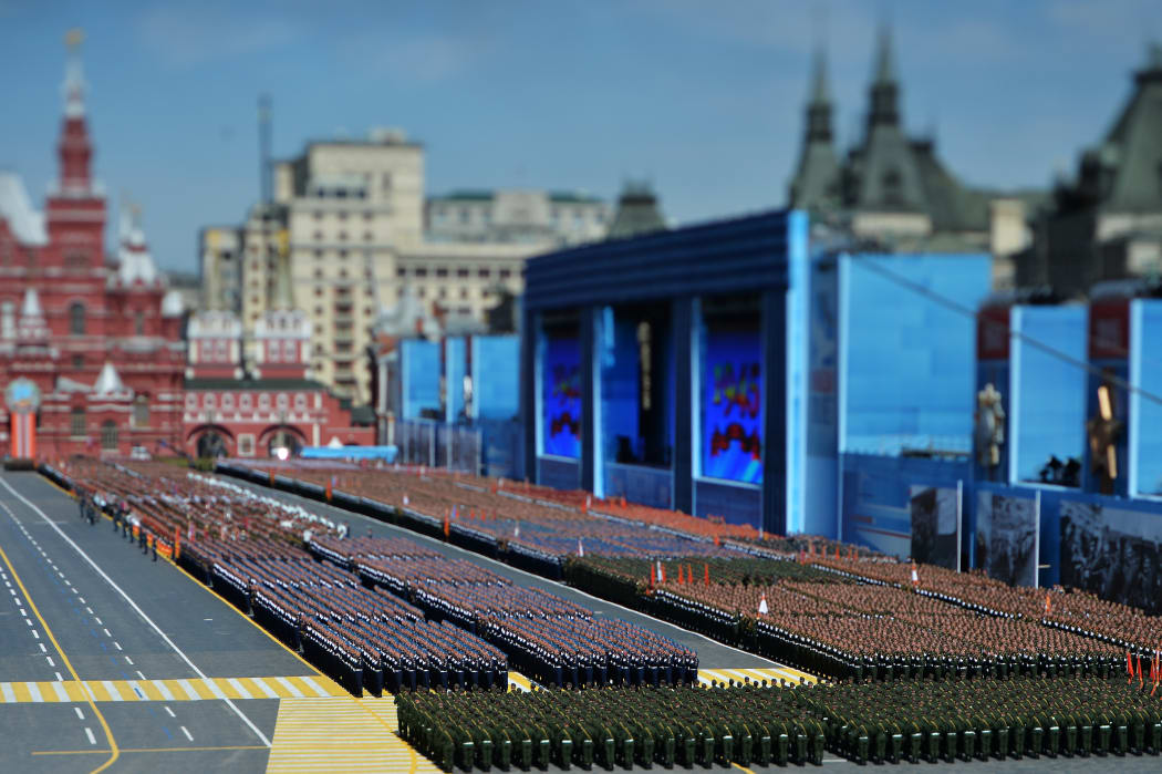 A photo taken with a tilt-shift lens shows soldiers marching through Red Square.