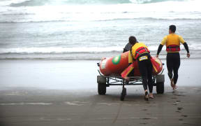 Lifeguards rush out to the sea