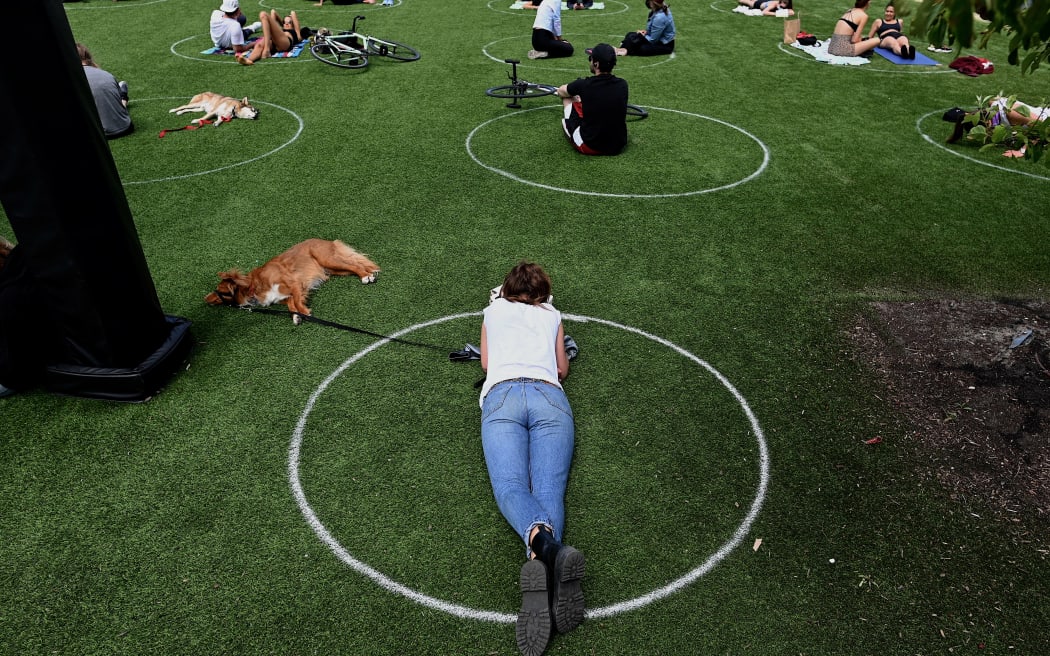People practising social distancing in white circles in Domino Park, during the Covid-19 pandemic on 17 May 2020 in the Brooklyn borough of New York City.
