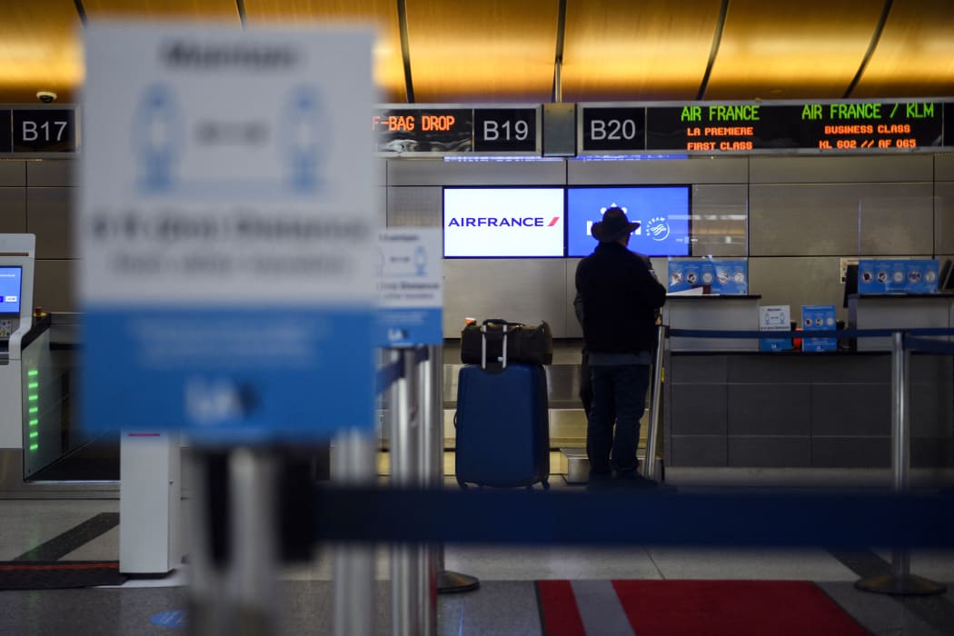 A passenger checks in for a flight at the Air France and KLM counter  at Los Angeles International Airport in January 2021.