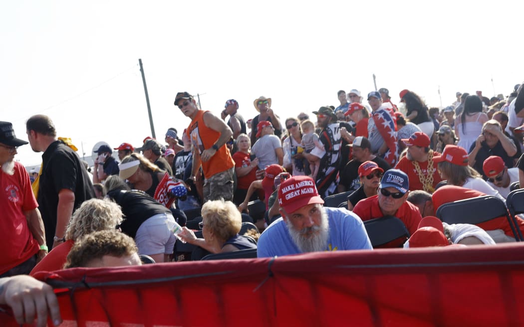 The crowd reacts after shots were fired at a republican rally for presidential candidate former President Donald Trump, on 13 July, 2024 in Butler, Pennsylvania.