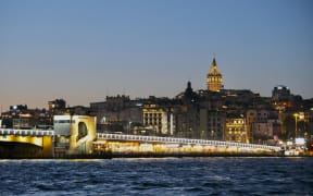 Turkey, Istanbul, Fatih district, Eminönü, Galata Bridge and Galata Tower in Beyoglu district, at night from a ferry on the Bosphorus Strait (Photo by OLART Fabien / Hemis.fr / hemis.fr / Hemis via AFP)