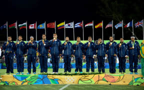 Fiji stand on the medal podium after winning gold during the Men's rugby sevens Final.