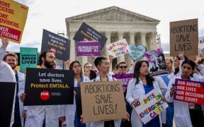 A group of doctors joined abortion rights supporters at a rally outside the Supreme Court on 24 April, 2024 in Washington, DC before a decision on whether Idaho emergency rooms can provide abortions to pregnant women during an emergency using a federal law known as Emtala.