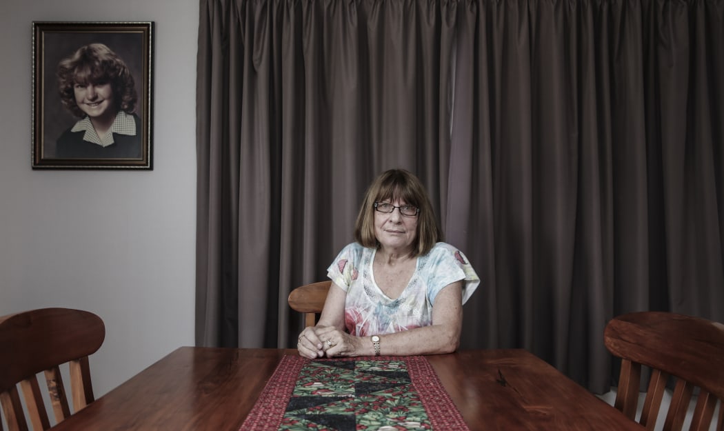 Robyn Jensen at home, 2017, under a photo of her missing daughter Kirsa.