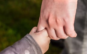 adult and kid hand