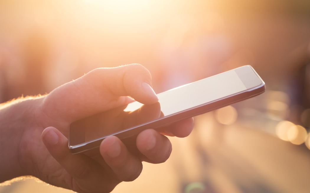 Man holding a mobile phone.