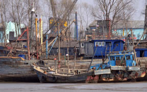 North Korean fishing vessels are docked on the banks of the Yalu River in the North Korean border town of Sinuiju on April 6, 2009 across the river from Dandong, in northeast China's Liaoning province.