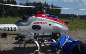 Members of the Yamaha team get the RMAX drone ready for takeoff.
