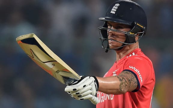 England's Jason Roy raises his bat after scoring a half century during the World T20 cricket semi-final match between England and New Zealand