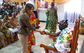 US First Lady Melania Trump shakes hands with Osabarimba Kwesi Atta II, the chieftan of the regional Fante tribe (R), at the Emintsimadze palace in Cape Coast, Ghana.