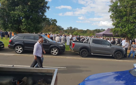 Family and friends of the late Imam Musa Patel pray behind his body during his funeral at Manukau.