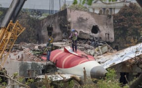 Members of Indian Army's engineering arm prepare to remove the wreckage of an Air India aircraft, bound for London's Gatwick Airport, which crashed during take-off from an airport in Ahmedabad, India June 14, 2025. (Photo by Basit Zargar / Middle East Images via AFP)