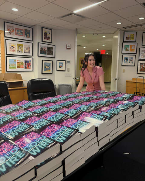Chloe Gong stands among dozens of her published Cold Wire books in New York.