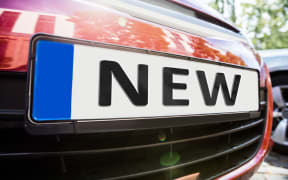 Close-up Of The License Plate Showing New Word On The Car