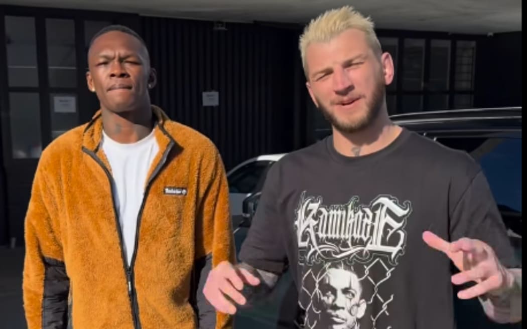 Israel Adesanya and Dan hooker announcing the 32 women backyard battle royal.