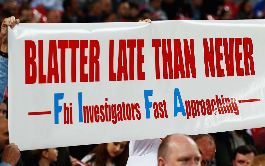 Fan holds a banner protesting against Sepp Blatter prior to Euro 16 qualifying match between England and Estonia at Wembley on October 9, 2015 in London.