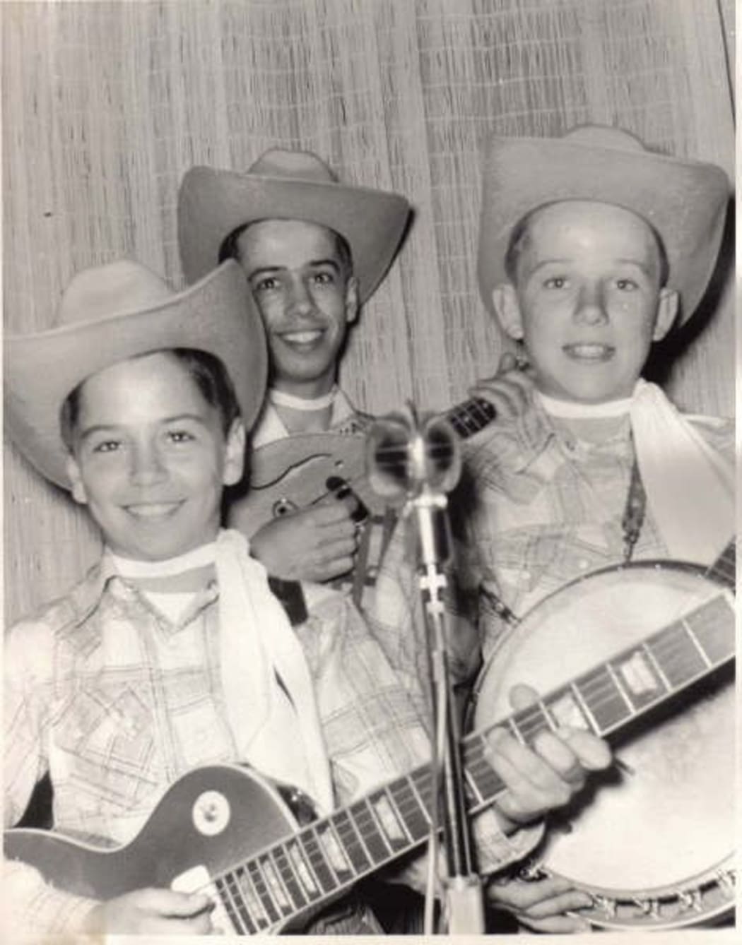 Clarence, Roland and Eric White as children, dressed as cowboys