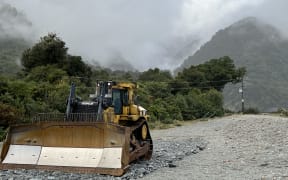 Bulldozer on Waiho River northern bank - single use only