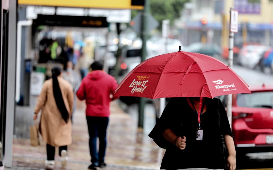 Woman walks in the rain.