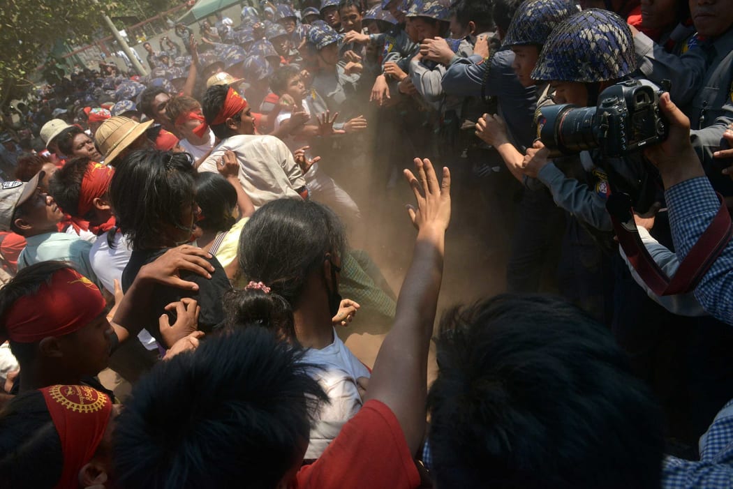 Myanmar student protesters (L) clash with riot police during a march in Letpadan town, some 130 kilometres (80 miles) north of Myanmar's main city on March 10, 2015.