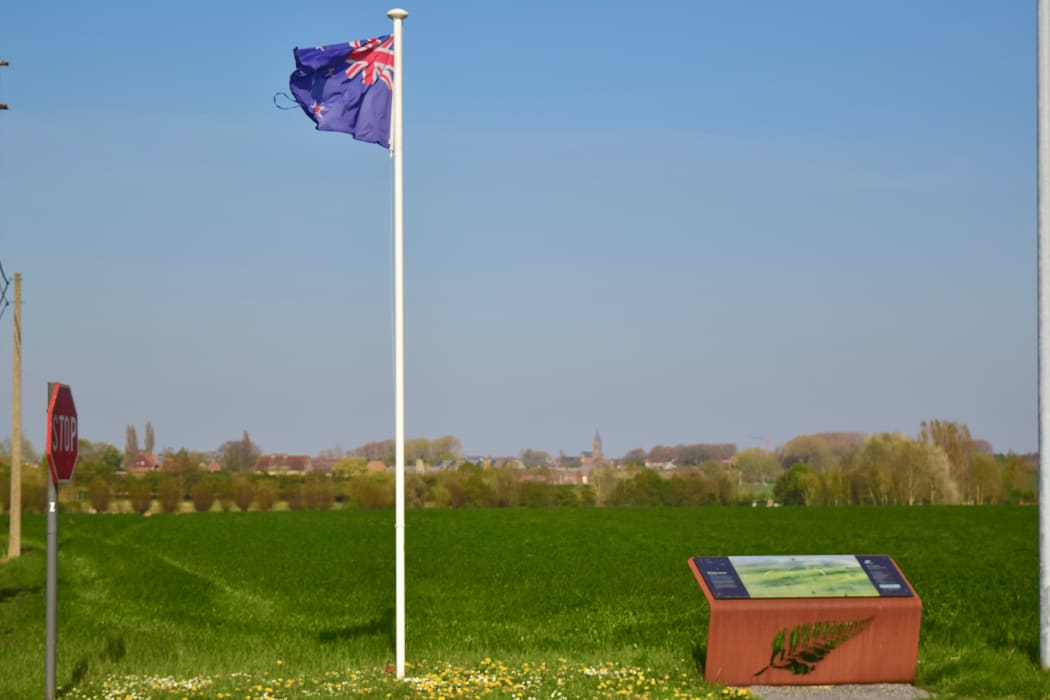 A New Zealand flag marks the frontline where Anzac soldiers advanced on October 12, 1917 - the church tower of Passchendaele is visible in the distance, just 2.5km away.