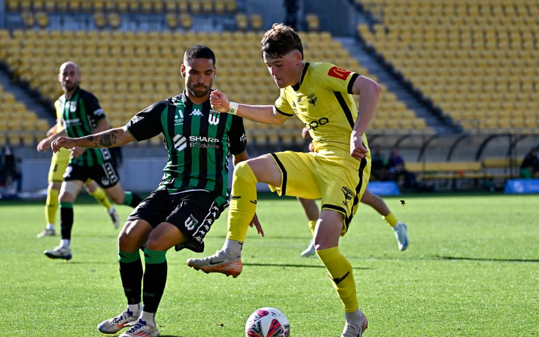 Tate Russell of Western United (L) and Nathan Walker of the Phoenix compete for the ball during their A-League match.