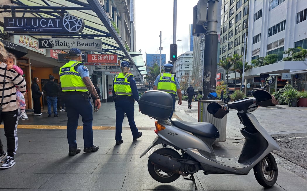 Police patrol on Queen Street.