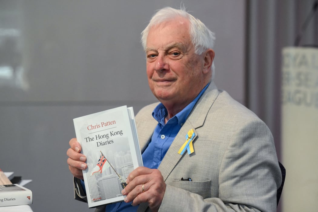 Former Hong Kong governor Lord Chris Patten, poses with his new book "The Hong Kong Diaries" at the end of a press conference to present it, in central London, on June 20, 2022. July 1, 2022 will mark 25 years since Hong Kong was handed to China by Britain. (Photo by Daniel LEAL / AFP)