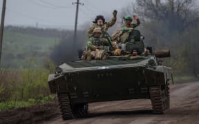 Ukrainian servicemen ride in a BMP infantry fighting vehicle near the town of Bakhmut, in the Donetsk region, on April 28, 2023, amid the Russian invasion on Ukraine. (Photo by Dimitar DILKOFF / AFP)