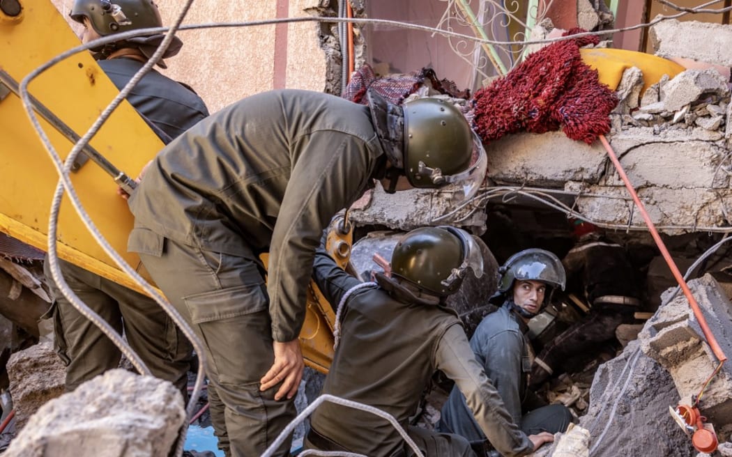 Rescue workers search for survivors in a collapsed house in Moulay Brahim, Al Haouz province, on September 9, 2023.