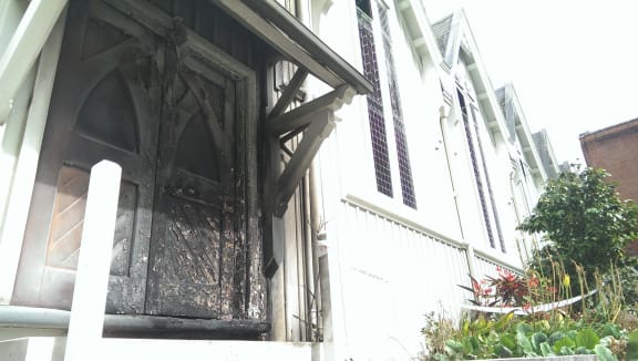 One of the doors to the church is charred.